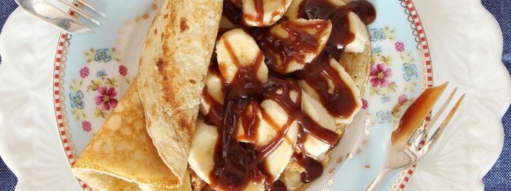Pancakes with banana, peanut butter and chocolate sauce
